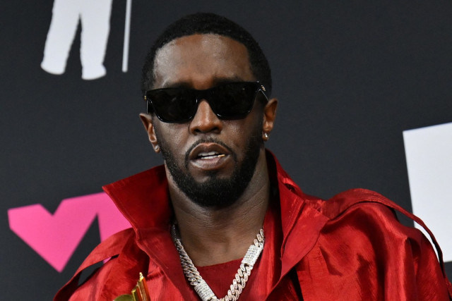 US producer-musician Sean "Diddy" Combs poses with the Global Icon award in the press room during the MTV Video Music Awards at the Prudential Center in Newark, New Jersey, on September 12, 2023