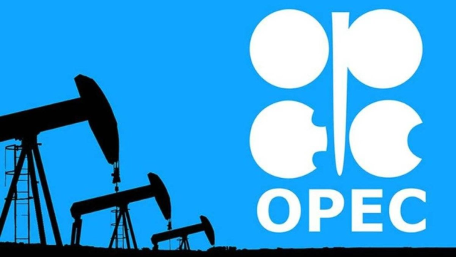 Picture of model of oil rigs in front of the OPEC logo