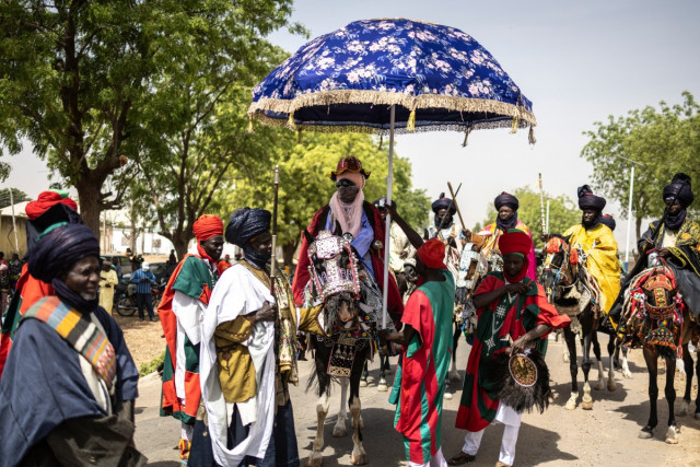 Muhammad Hameen Nuhu Sunusi (C), Emir of Dutse, rides during the Durbar horse procession in Dutse on March 31, 2025. Durbar is a colourful procession of horses dating back to the 15th century in which the emir and thousands of horse riders accompanied mus