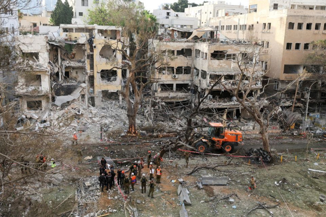 Emergency personnel work at an impact site after missiles were launched from Iran to Israel, in Tel Aviv, Israel.